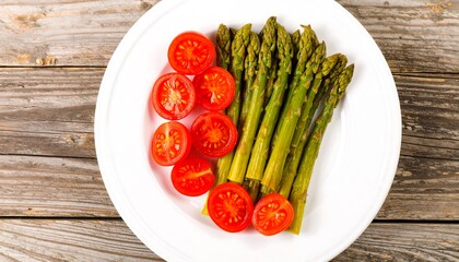 Fresh asparagus and cherry tomatoes on a white plate (1)