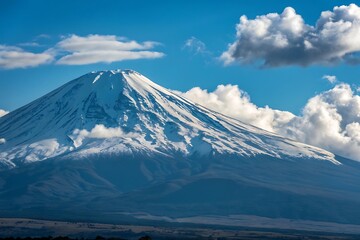 Majestic mount fuji peak under a blue sky with fluffy clouds