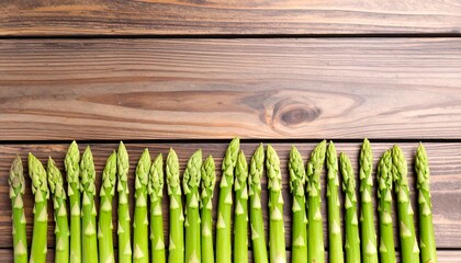 Fresh asparagus spears arranged on a wooden surface (1)
