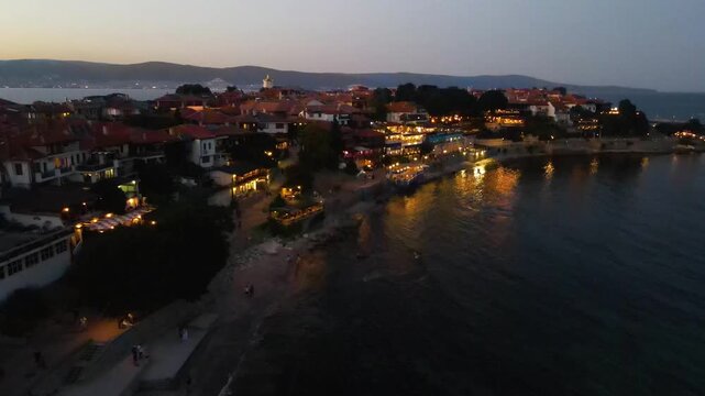 Night aerial view of the center of old Nessebar, houses, churches. Drone view from above. Summer holidays destination
