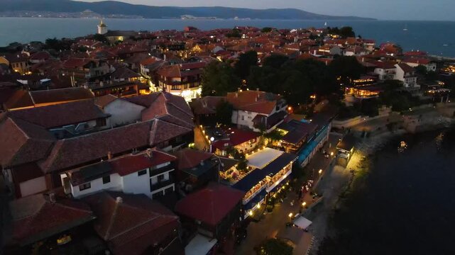 Night aerial view of the center of old Nessebar, houses, churches. Drone view from above. Summer holidays destination
