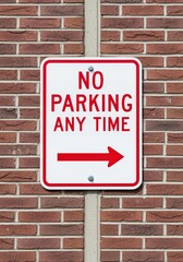 Obraz premium No Parking Any Time Sign with Arrow on Brick Wall
