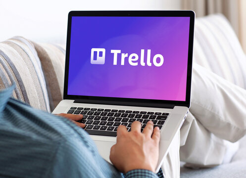 Businessman working from home using trello project management software on laptop