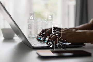 Person typing on laptop with digital interface icons showing AI productivity, checklist, data...
