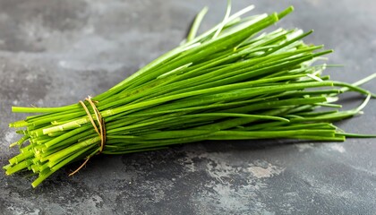 Fresh chives bunch on dark surface (1)