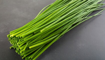 Fresh chives bunch on dark surface