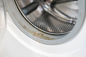 Old rusty broken washing machine isolated on white background.