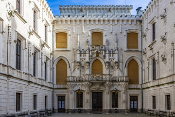 Fototapeta premium Neo-gothic courtyard facade with arched windows and decorative elements at historical building