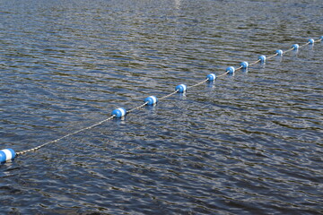 Swimming and summertime. Limits on a lake for the swimming. Summer and fun. Lake or river background. Limits fro swimming zone and security. Boundary buoys and safety beacons. © Martine