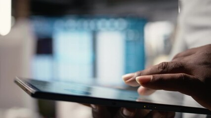 African american developer evaluating 3D models blueprints and digital software as part of strategic housing project in urban development area. City planning business project on tablet. Camera A. - Powered by Adobe