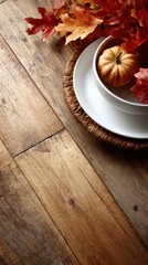 Thanksgiving table displays pumpkin, bowl, plate, autumn leaves on rustic wood, copy space.