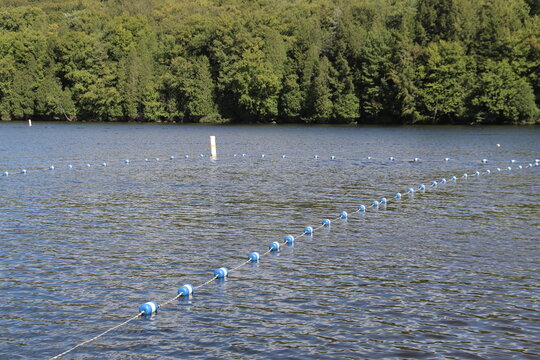Swimming and summertime. Limits on a lake for the swimming. Summer and fun. Lake or river background. Limits fro swimming zone and security. Boundary buoys and safety beacons	.