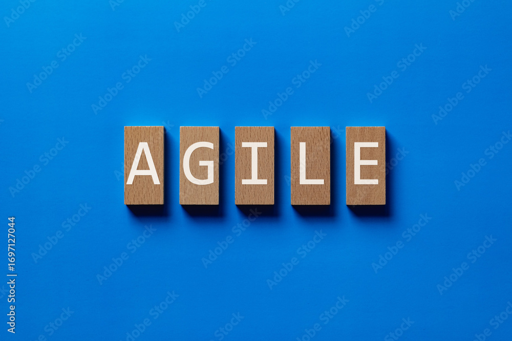 Poster there is wood block with the word agile. it is as an eye-catching image.