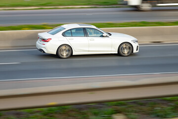 Highway Pulse: White Sedan on the Move