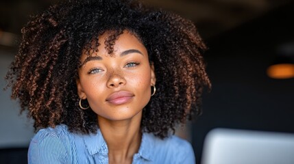 Young woman with curly hair looking straight at the viewer