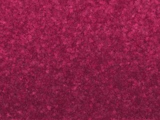 Deep magenta abstract background with a textured, speckled pattern.