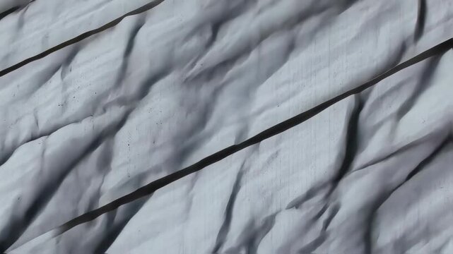 Abstract grayscale texture with diagonal folds