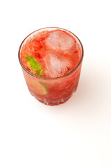 A vibrant red strawberry cocktail or mocktail with crushed ice and a lime wedge garnish, served in a classic glass on a clean white background, perfect for party promotions, and beverage advertisement