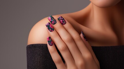 A woman's hand with beautifully manicured nails featuring a bold, colorful polka dot design. The hand is gently touching her shoulder.