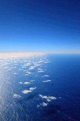 aerial view of vast ocean surface showcasing mesmerizing patterns created by clouds casting shadows on water