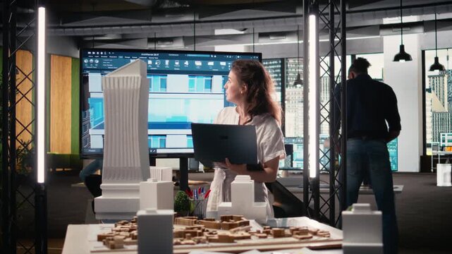 Woman real estate developer works with 3D tools and digital blueprints used for urban planning, finalizing site preparation and structural housing design for a modern residential project. Camera A.