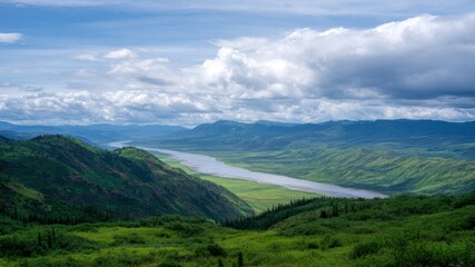 Obraz premium Sunset kayaking in valley river view under dramatic cloud sky over green hillside and distant mountain ridge feeling peaceful and free