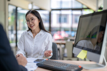 Fototapeta premium Businesswoman explaining business plan to her colleague in the office