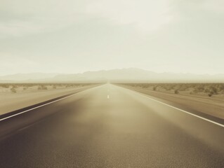 Naklejka premium Endless desert road vanishing into the horizon with soft daylight and mountain silhouettes in the distance, minimalist travel and landscape concept