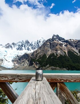 Mountain lake vista with a metal thermos