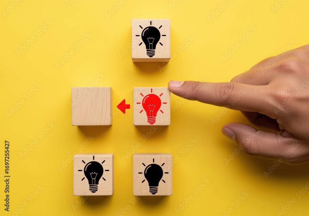 Poster hand selecting a glowing lightbulb idea block