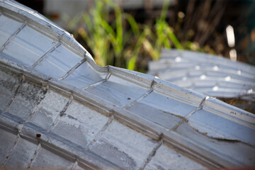 Roof tiles in a garden, detail of roofing material.