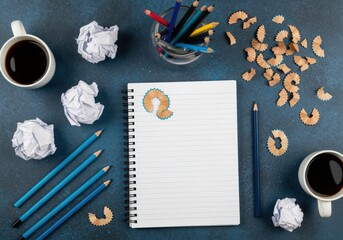 Creative workspace with blank notepad, pencils, coffee