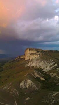 Mountain landscape at sunset with storm clouds