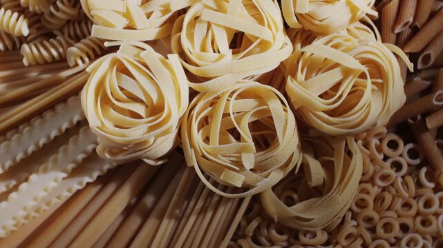 Pasta mix, different Italian tagliatelle fussili pasta packaging window, Fettuccine pasta, close up, not cooked