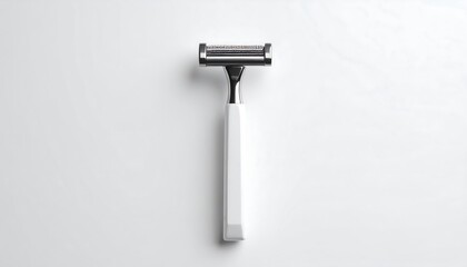 A white-handled, stainless steel razor lies flat on a white surface