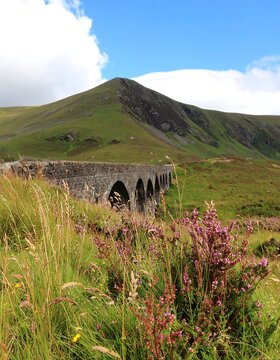 Mountain landscape with arched bridge