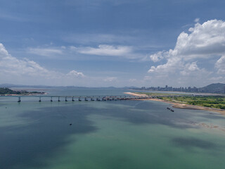 Coastal Cityscape: Aerial View of a Sea Bridge and Modern Urban Skyline