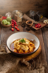 Traditional Asian Chicken and Egg Drop Soup in White Bowl on Rustic Wood Table