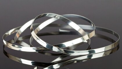 Silver Metallic Ribbons Forming a Helix on Dark Background