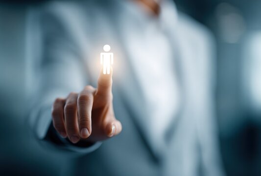 Woman taps glowing human icon, conveying technology, connections, and modern professional engagement in a bright, blurred setting