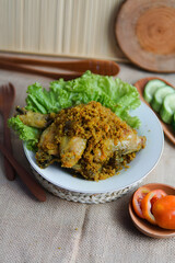 Baked Chicken Leg with Green Lettuce and Vegetable Slices on White Plate