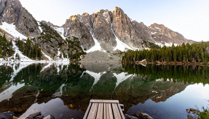 Tranquil Wilderness Landscape: Pine Forest, Lake, and Snow-Capped Peaks