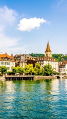 Obraz premium Picturesque European city views along a calm river, displaying colorful buildings and lush greenery under a vibrant blue sky.