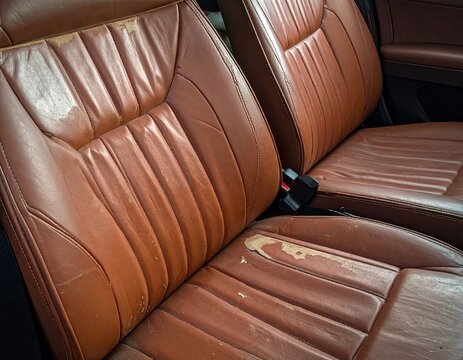 Fototapeta Closeup Worn Brown Leather Car Seats