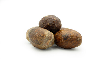 Dried nutmeg or seed of Myristica fragrans, or biji pala. Isolated on white background