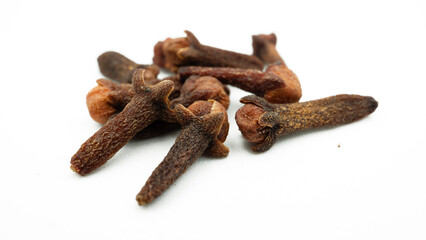 Fototapeta premium Cengkeh or cloves are aromatic dried flower buds. Dried cloves isolated on white background with clipping path. Flat lay or top view.