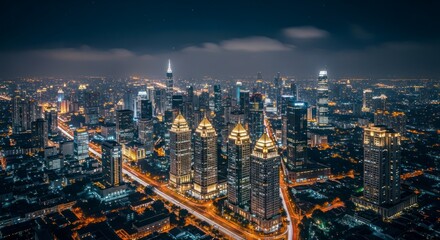 Obraz premium Aerial View of a Modern Metropolis at Night.