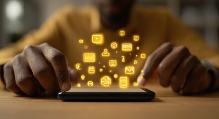 Dark-skinned man interacts with glowing app icons floating above a phone on a brown table in soft focus