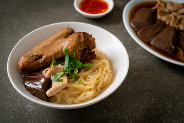 dried noodles with braised duck in white bowl