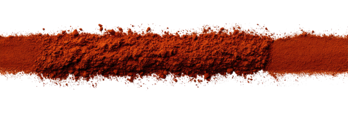 A long, horizontal swath of dark-red, powdered spice, with small, scattered particles of various colors